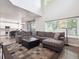 Open floor plan living room offering an expansive layout with a large sofa and abundant light at 9816 S Holland St, Littleton, CO 80127