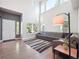 Bright living room with tall windows, hardwood floors, and a gray sofa at 9816 S Holland St, Littleton, CO 80127