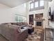 Spacious living room with large windows, fireplace, and comfortable sectional sofa at 9816 S Holland St, Littleton, CO 80127