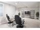 Finished basement area features two gaming chairs, a TV, and shelves perfect for hosting or relaxing at 9816 S Holland St, Littleton, CO 80127