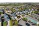 Wide aerial view capturing a vibrant community with diverse homes, solar panels, and mature landscaping at 10822 E 28Th Pl, Denver, CO 80238