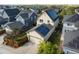 Aerial view of home with solar panels, surrounded by a well-manicured lawn and neighboring houses at 10822 E 28Th Pl, Denver, CO 80238