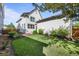 Well-maintained backyard with green lawn, tidy landscaping, and a view of the home's exterior at 10822 E 28Th Pl, Denver, CO 80238