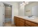Bathroom with wood cabinets, tub and shower, plus a neutral-toned countertop at 10822 E 28Th Pl, Denver, CO 80238