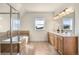 Luxurious bathroom with a glass-enclosed shower, soaking tub, double vanity, and warm lighting at 10822 E 28Th Pl, Denver, CO 80238