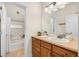 Bathroom with wood cabinets, tub and shower, plus a neutral-toned countertop at 10822 E 28Th Pl, Denver, CO 80238