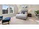 Well-lit bedroom featuring neutral decor, lots of natural light, and a comfortable queen bed at 10822 E 28Th Pl, Denver, CO 80238