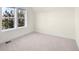 Neutral bedroom with carpet and natural light from a large window at 10822 E 28Th Pl, Denver, CO 80238