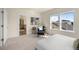 Cozy bedroom with a sitting area, large windows, and an ensuite bathroom with a separate shower and tub at 10822 E 28Th Pl, Denver, CO 80238