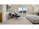 Bright bedroom with a cozy sitting area, lots of natural light, and a comfortable queen bed at 10822 E 28Th Pl, Denver, CO 80238