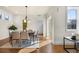 Well-lit dining room with wood floors, a modern light fixture, and stylish seating for six at 10822 E 28Th Pl, Denver, CO 80238