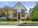 Charming two-story home featuring a welcoming front porch and meticulously maintained landscaping at 10822 E 28Th Pl, Denver, CO 80238