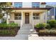 Inviting front porch with classic columns, decorative wreath, and manicured landscaping at 10822 E 28Th Pl, Denver, CO 80238