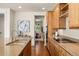 Well-lit kitchen featuring wood cabinets, granite countertops, stainless steel sink, and hardwood flooring at 10822 E 28Th Pl, Denver, CO 80238