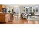 Open floor plan showcases kitchen, dining area, and living room with wood floors and ample natural light at 10822 E 28Th Pl, Denver, CO 80238