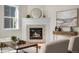 Charming fireplace with stone surround, modern mantel, and stylish decor enhances this inviting living space at 10822 E 28Th Pl, Denver, CO 80238