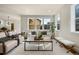 Bright living room with large windows, neutral decor, comfortable seating, and lots of natural light at 10822 E 28Th Pl, Denver, CO 80238
