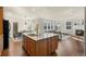 Bright kitchen with island seamlessly flows to the living room with fireplace, creating an inviting open layout at 10822 E 28Th Pl, Denver, CO 80238