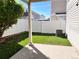 Backyard with a covered patio featuring artificial turf grass and white vinyl fencing at 5566 Flanders St, Denver, CO 80249