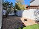 Landscaped backyard featuring gravel, paver walkway, and a white vinyl fence at 5566 Flanders St, Denver, CO 80249