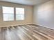 Bright bedroom with light-colored walls, and modern wood-look vinyl plank flooring at 5566 Flanders St, Denver, CO 80249
