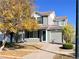 Charming two-story home with landscaped front yard and gray vinyl siding at 5566 Flanders St, Denver, CO 80249