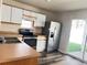 Functional kitchen featuring stainless steel appliances, great for cooking and entertaining, with an adjacent dining area at 5566 Flanders St, Denver, CO 80249