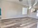 Open-concept living room with hardwood floors, ideal for gatherings and everyday living, conveniently located off kitchen at 5566 Flanders St, Denver, CO 80249