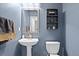 Small bathroom with pedestal sink and blue walls at 17101 Waterhouse Cir # B, Parker, CO 80134