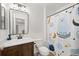 Bathroom with wood vanity and fun shower curtain at 17101 Waterhouse Cir # B, Parker, CO 80134