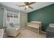 Bedroom with green accent wall and ceiling fan at 17101 Waterhouse Cir # B, Parker, CO 80134