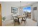 Dining area with wooden table, four chairs, and sliding doors at 17101 Waterhouse Cir # B, Parker, CO 80134