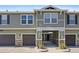 Green two-story townhome with attached garage and landscaping at 17101 Waterhouse Cir # B, Parker, CO 80134