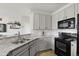 Eat-in kitchen with black appliances and gray cabinets at 17101 Waterhouse Cir # B, Parker, CO 80134