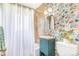 Bathroom featuring floral wallpaper, a shower and bath combo, and a unique sink, offering a cheerful space at 2756 S Linley Ct, Denver, CO 80236