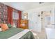 Inviting bedroom with colorful wallpaper, closet, and a view to the bathroom, providing a relaxing space at 2756 S Linley Ct, Denver, CO 80236