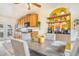 Bright kitchen with wooden cabinets, modern appliances, and a cozy dining area with stylish decor at 2756 S Linley Ct, Denver, CO 80236