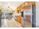 Well-equipped kitchen featuring stainless steel appliances, wooden cabinets, and a dining area at 2756 S Linley Ct, Denver, CO 80236