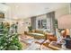 Bright and airy living room with a comfortable couch and stylish mid-century modern furniture at 2756 S Linley Ct, Denver, CO 80236