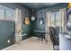 Office space equipped with instruments, multiple windows, and dark walls; great for working or playing music at 2756 S Linley Ct, Denver, CO 80236