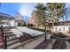 Landscaped backyard with steps leading to a patio and detached shed at 12019 W Mexico Ave, Lakewood, CO 80228