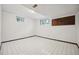 Basement bedroom featuring tiled flooring and dual windows at 12019 W Mexico Ave, Lakewood, CO 80228