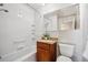 Updated bathroom with tub and granite countertop at 12019 W Mexico Ave, Lakewood, CO 80228