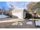 Detached garage with double doors and a spacious paved driveway at 12019 W Mexico Ave, Lakewood, CO 80228