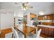 Open dining area with hardwood floors and kitchen access at 12019 W Mexico Ave, Lakewood, CO 80228