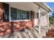 House entrance with brick facade, white columns, and lattice at 12019 W Mexico Ave, Lakewood, CO 80228