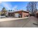 Brick house exterior with a storage shed and a paved area at 12019 W Mexico Ave, Lakewood, CO 80228