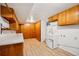 Basement laundry room with cabinets and utility sink at 12019 W Mexico Ave, Lakewood, CO 80228