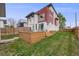 A fenced yard features a cozy deck, patio, and lush lawn at 4390 Osage St, Denver, CO 80211