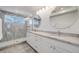 A modern bathroom featuring dual sinks, granite countertops and a large shower with tiling at 4390 Osage St, Denver, CO 80211